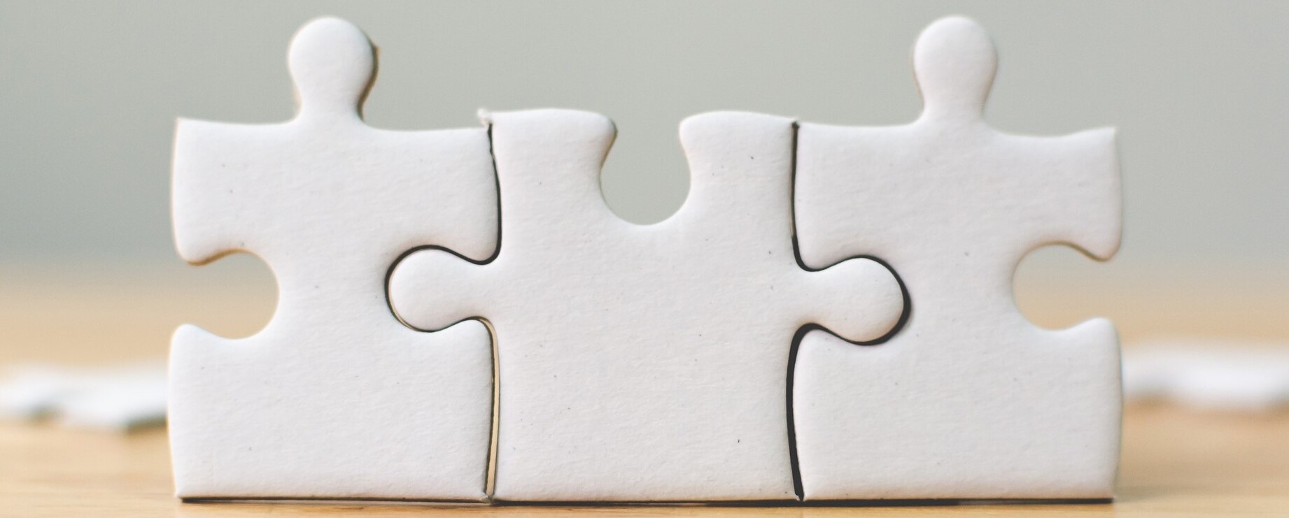 White jigsaw puzzle connecting together. Team business success partnership or teamwork concept